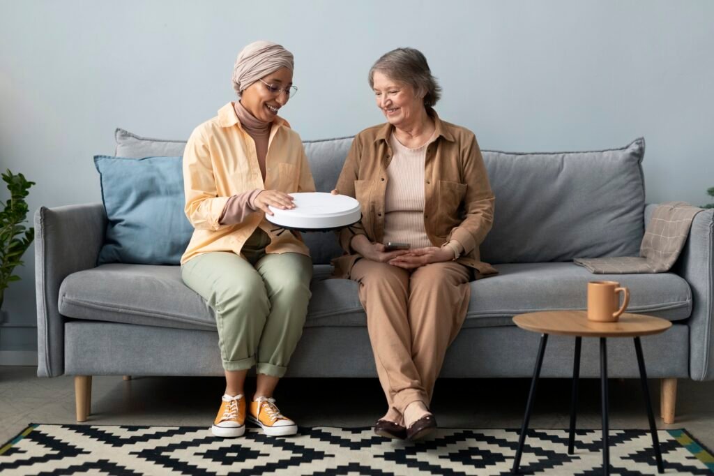 arabic-woman-teaching-senior-woman-use-led-lamp-with-smartphone